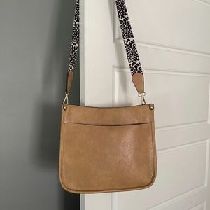 Ahdorned crossbody bag with strap.